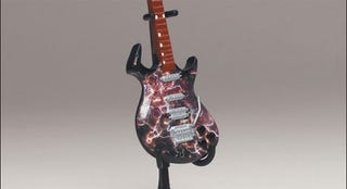 Illustration for article titled McFarlane's Tiny, Plastic Guitar Hero Guitars