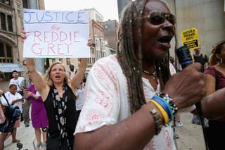 A small and peaceful group of demonstrators gather to protest in front of the Baltimore City Circuit Courthouse East, where pretrial hearings will be held for six police officers charged in the death of Freddie Gray Sept. 2, 2015, in Baltimore.Chip Somodevilla/Getty Images