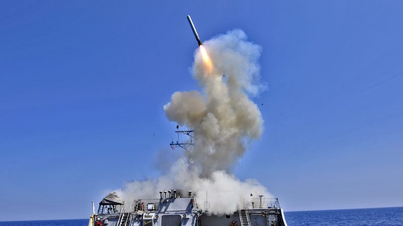 A U.S. Navy guided-missile destroyer, USS Barry (DDG 52), launching Raytheon-manufactured Tomahawk missiles during the opening phases of the international military intervention that ended in the overthrow of the Libyan government in 2011.
