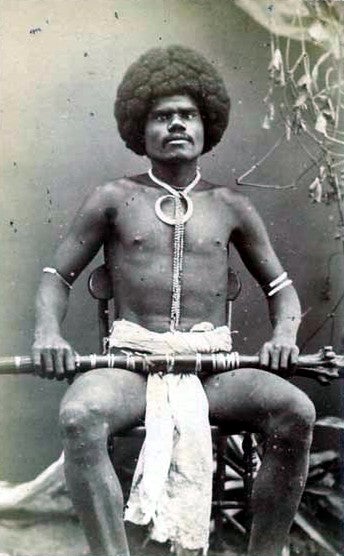 Pictured holding a rootstock club and wearing a boar's tusk necklace is Fijian mountain warrior Kai Colo, 1870s. Fiji is part of Melanesia, a region from which many West Indians can trace some of their heritage.Wikimedia Commons