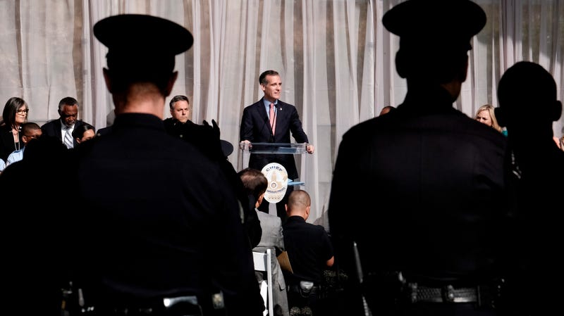 LAPD officers watch as Los Angeles Mayor Eric Garcetti swears in veteran Michel Moore as the new chief of police in July 2018.