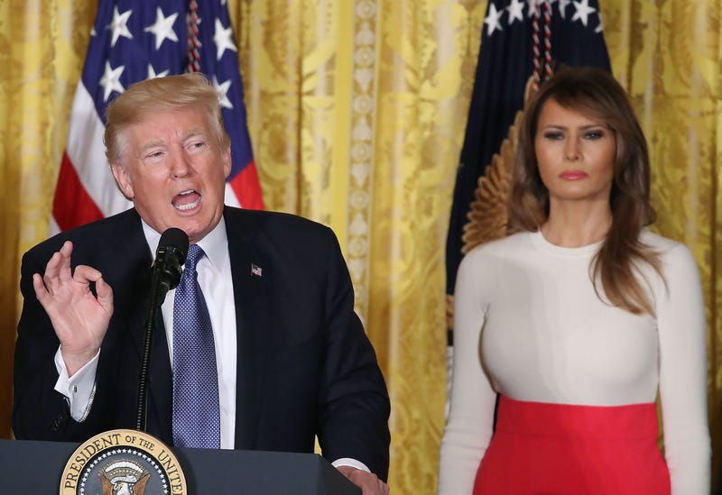 President Donald Trump is flanked by first lady Melania Trump as he speaks to guests gathered in the East Room of the White House in Washington, D.C., to celebrate Hispanic Heritage Month on Oct. 6, 2017. (Mark Wilson/Getty Images)