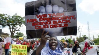 A woman holds a sign as members of Lagos-based civil-society groups hold rally calling for the release of missing Chibok schoolgirls at the state government house in Lagos, Nigeria, May 5, 2014. PIUS UTOMI EKPEI/AFP/Getty Images