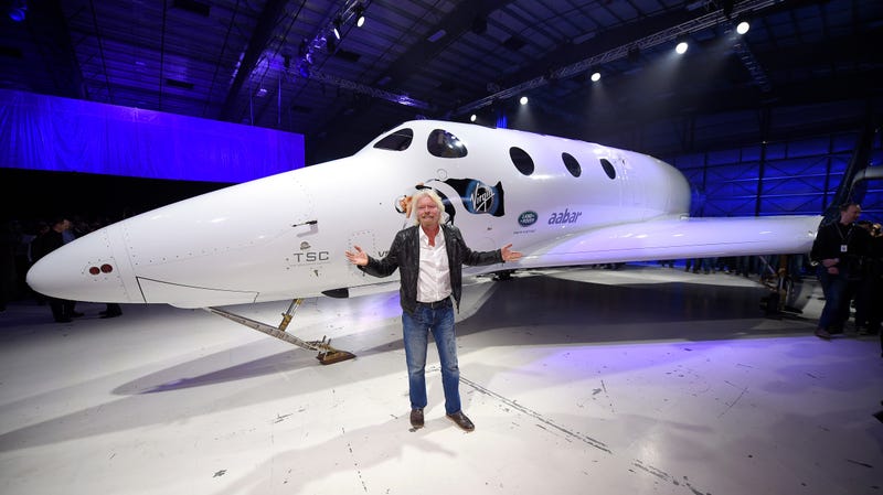 Sir Richard Branson poses in front of Virgin Galactic’s SpaceShipTwo space tourism rocket after it was unveiled, Friday, Feb. 19, 2016, in Mojave, Calif.