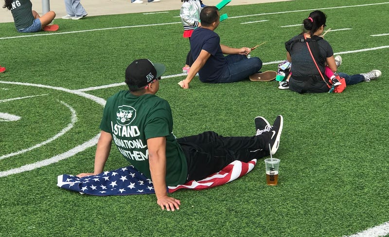 Jets fan sits on American flag Zzypmujoegofwxs2rukr