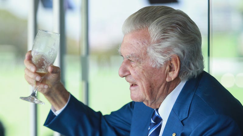 Former Australian Prime Minister Bob Hawke finishes a cold beer while watching a cricket match in 2018.