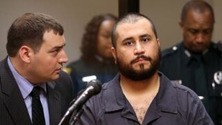 George Zimmerman, who was acquitted in the shooting death of Trayvon Martin, with his defense counsel (left) at a hearing on charges including aggravated assault stemming from a fight with his girlfriend Nov. 19, 2013, in Sanford, Fla.Joe Burbank-Pool/Getty Images