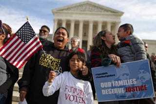 Rosario Reyes (behind flag) and her son Victor Reyes during a vigil and rally organized by the Fair Immigration Reform Movement and CASA in front of the Supreme Court in Washington, D.C., Dec. 11, 2015.Chip Somodevilla/Getty Images