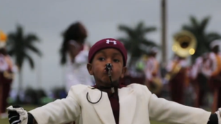 Drum major Taranza McKelvin leads the battle of the bands at the Muck Bowl.Screenshot from Palmbeachpost.com