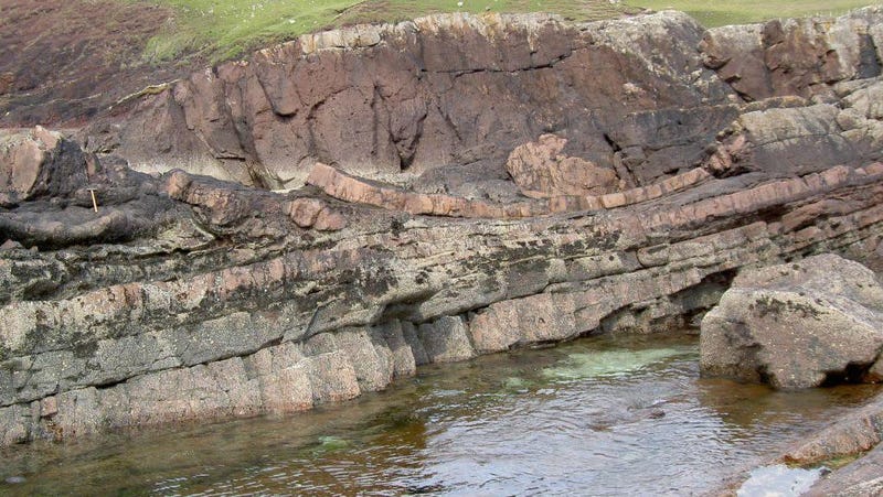 Reddish-colored rocks of the Stac Fada deposit. 
