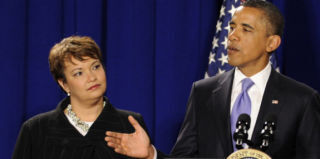 President Barack Obama talks to Environmental Protection Agency as EPA Administrator Lisa Jackson listens. (Pool/Getty)