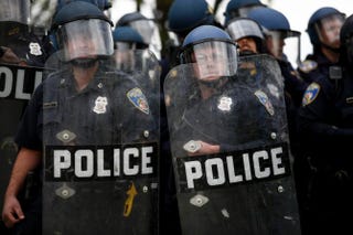 Police officers in riot gear look toward protesters along Reisterstown Road near Mondawmin Mall April 27, 2015, in Baltimore.Drew Angerer/Getty Images