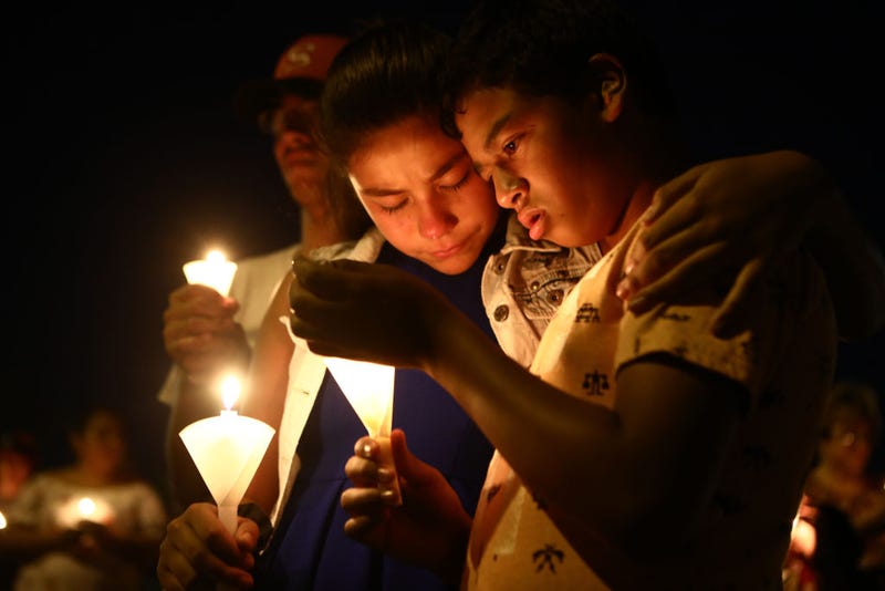 People attending a candlelight vigil in honor of the El Paso victims