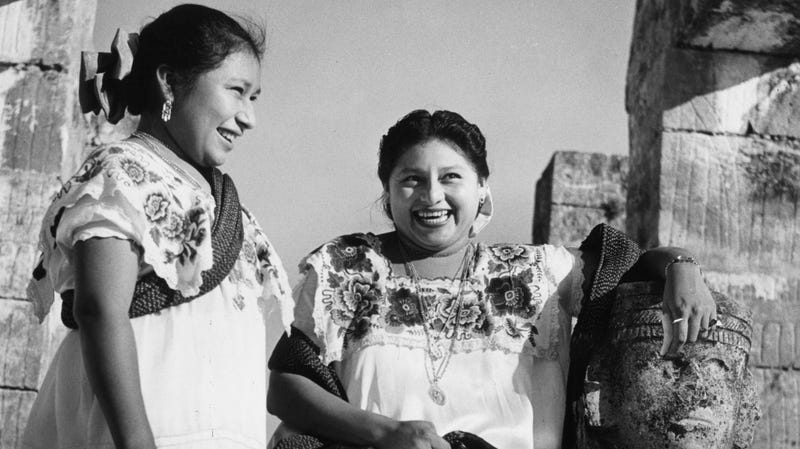 Two Mayan women visit the Temple of the Warriors circa 1950.