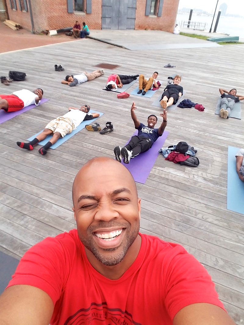 Changa Bell (front), founder of the Black Male Yoga Initiative, with studentsCourtesy of Changa Bell