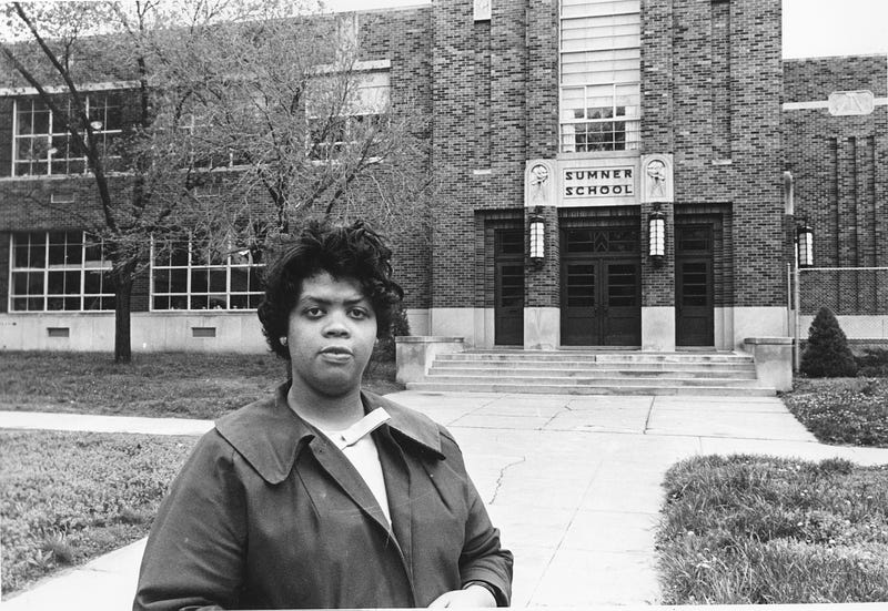 Linda Brown Smith stands in front of the Sumner School in Topeka, Kan., on May 8, 1964. The refusal of the public school to admit Brown in 1951, then 9 years old, because she is black led to the Brown v. Board of Education of Topeka, Kansas case. In 1954 the U.S. Supreme Court overruled the “separate but equal” clause and mandated that schools nationwide be desegregated.