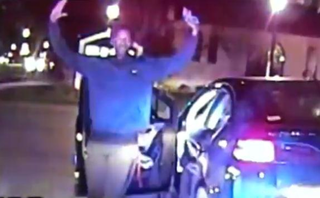 Dashcam footage shows Lawrence Crosby exiting his car holding what police would later learn is a cellphone. (CBS screenshot)