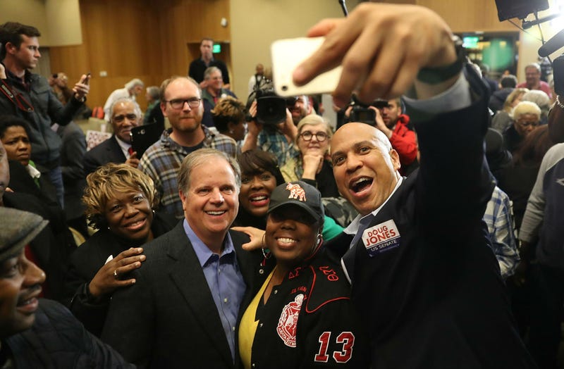 Democratic senatorial candidate Doug Jones (front, second from left) takes a group picture with Sen. Cory Booker (right) and Rep. Terri Sewell (third from right) and supporters during a campaign event at Alabama State University at the John Garrick Hardy University Student Center on Dec. 9, 2017, in Montgomery, Ala. (Joe Raedle/Getty Images)