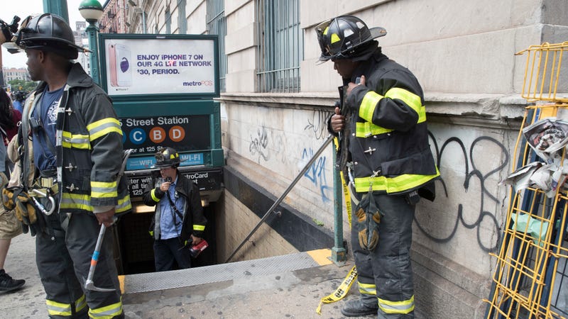 Emergency service personnel work at the scene of a subway derailment, Tuesday, June 27, 2017, in the Harlem neighborhood of New York. A subway train derailed near a station in Harlem on Tuesday, frightening passengers and resulting in a power outage as people were evacuated from trains along the subway line. The Fire Department of New York said a handful of people were treated for minor injuries at around 10 a.m. It said there was smoke but no fire. Delays were reported throughout the subway system. (AP Photo/Mary Altaffer)