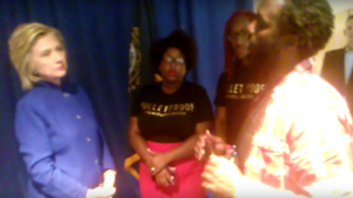 Former Secretary of State and presidential candidate Hillary Clinton listens as Black Lives Matter activist Julius Jones addresses her on issues surrounding mass incarceration after a recent campaign event in New Hampshire.Youtube/GOOD