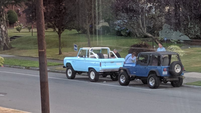 She seems to be admiring the Jeep as well