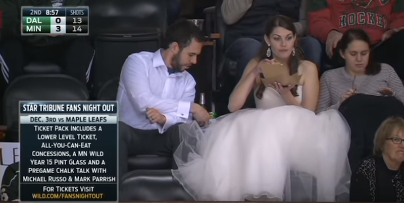 Illustration for article titled The Greatest Baller Of All: This Woman In A Wedding Dress At A Minnesota Wild Game