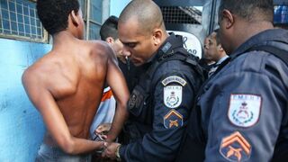A suspect is handcuffed by military police during a joint operation including the CORE police special forces near the Complexo do Alemao pacified community, or “favela,” on May 13, 2014, in Rio de Janeiro.Mario Tama/Getty Images