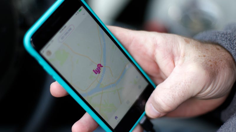 A Lyft driver opens the Lyft app on his phone while waiting for the fare in Pittsburgh.