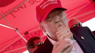 Republican presidential candidate Donald Trump eats a pork chop on a stick and gives a thumbs-up sign to fairgoers at the Iowa State Fair Aug. 15, 2015, in Des Moines.Win McNamee/Getty Images