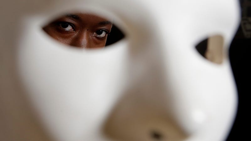 Massachusetts Institute of Technology facial recognition researcher Joy Buolamwini stands for a portrait behind a mask at the school, in Cambridge, Mass. Buolamwini’s research has uncovered racial and gender bias in facial analysis tools sold by companies such as Amazon that have a hard time recognizing certain faces, especially darker-skinned women.
