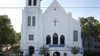 People stand outside the Emanuel African Methodist Episcopal Church in Charleston, S.C., June 18, 2015, after a mass shooting at the church the night before that left nine people dead. Emanuel AME Church is one of the oldest in the South. Joe Raedle/Getty Images