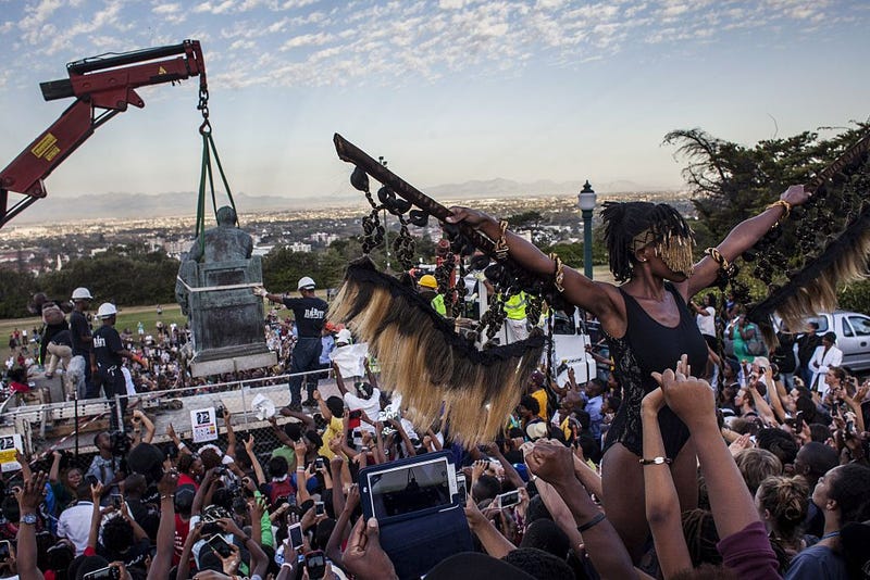 Students cheer as the Cecil Rhodes statue is being removed from the University of Cape Town on April 9, 2015, in South Africa.