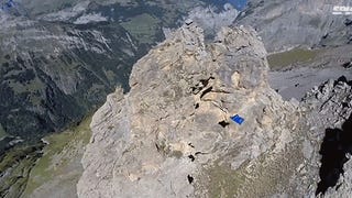 Video: Flying man in wing suit slices right through a hole in a mountain