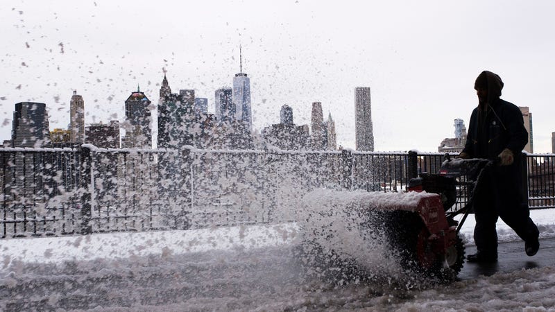 A worker blasting some dirty-ass snow