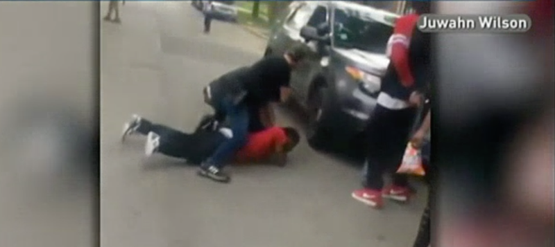 A plainclothes police officer is seen straddling Jermaine Milan in Chicago. (NBC Chicago)