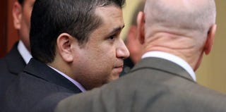 George Zimmerman confers with his lawyer in court after his acquittal. (Pool/Getty Images)