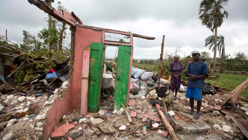 Saintanor Dutervil stands with his wife in the ruins of their home destroyed by Hurricane Matthew in Les Cayes, Haiti, Thursday, Oct. 6, 2016. Two days after the storm rampaged across the country’s remote southwestern peninsula, authorities and aid workers still lack a clear picture of what they fear is the country’s biggest disaster in years.