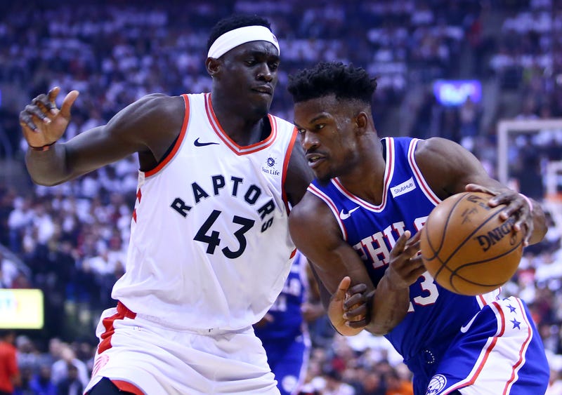 Jimmy Butler of the Philadelphia 76ers, right, dribbles the ball as Pascal Siakam of the Toronto Raptors defends during Game One of the second round of the 2019 NBA Playoffs at Scotiabank Arena on April 27, 2019 in Toronto, Canada.
