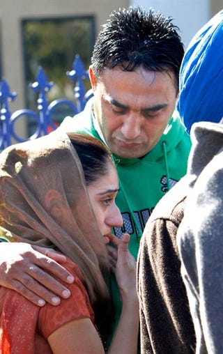The children of hate-crime victim Surinder Singh (AP)