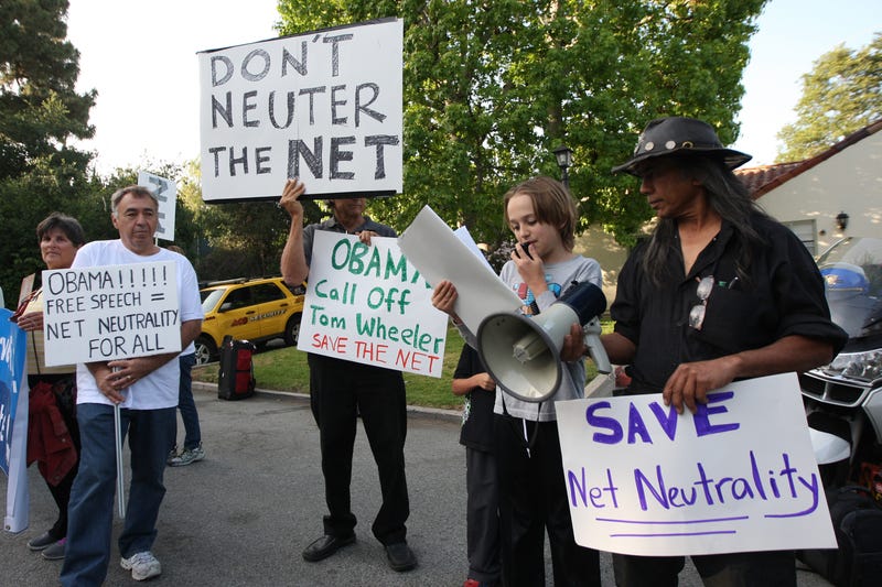 People demonstrate for net neutrality in the exclusive neighborhood of Bel-Air outside a USC Shoah Foundation fundraiser to be attended by President Barack Obama on May 7, 2014 in Los Angeles, California.