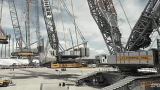 A giant crane lifting a huge crane lifting a big crane lifting a crane