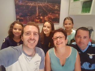 Miguel García Casado con la familia a la que acogió. El retrato grupal se ha convertido en en símbolo de solidaridad. Fuente: Cuenta en Twitter.