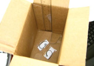 Illustration for article titled Motorola Sends Teeny Ear Clips In Huge Cardboard Box