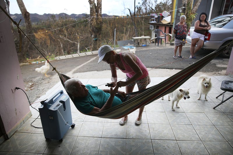 Irma Maldanado checks on her father, Ignacio Maldanado Ortiz, who uses an oxygen machine because of his emphysema on Oct. 2, 2017, in Corozal, Puerto Rico. Irma Maldanado said her father is in need of oxygen but has no way of getting a supply in the aftermath of Hurricane Maria. (Joe Raedle/Getty Images)