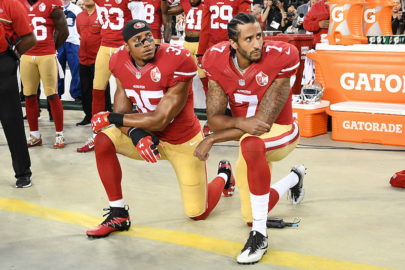 Colin Kaepernick, No. 7, and Eric Reid of the San Francisco 49ers kneel in protest during the national anthem before playing the Los Angeles Rams at Levi’s Stadium in Santa Clara, Calif., on Sept. 12, 2016. (Thearon W. Henderson/Getty Images)