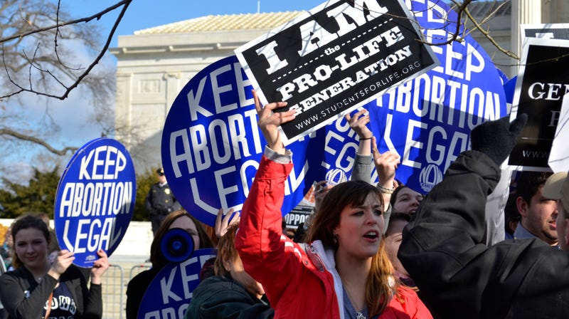 A pro-life woman clashing with a group of pro-choice demonstrators at the U.S. Supreme Court in 2015