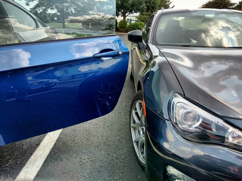 Illustration for article titled Coworker's Subieyota left enough room for me to open my car's gigantic doors!