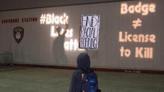 Protesters interact with messages projected on the wall of a police station Jan. 17, 2015, after an anti-police-brutality march in Oakland, Calif.Josh Edelson/Getty Images