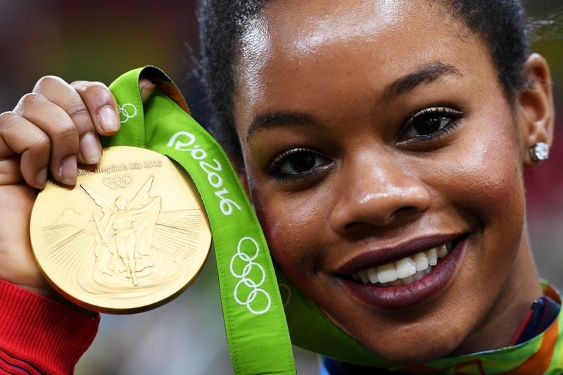 Gabby Douglas poses with her Olympic gold medal after the medal ceremony for the Artistic Gymnastics Women's Team at the Rio de Janeiro Olympics on Aug. 9, 2016.Laurence Griffiths/Getty Images