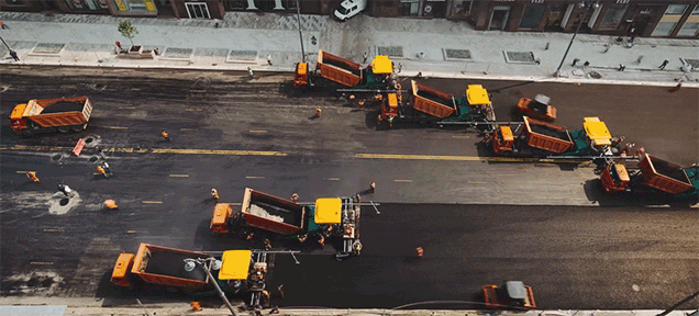 Watch a Huge Swarm of Machines Pave a Road in Russia